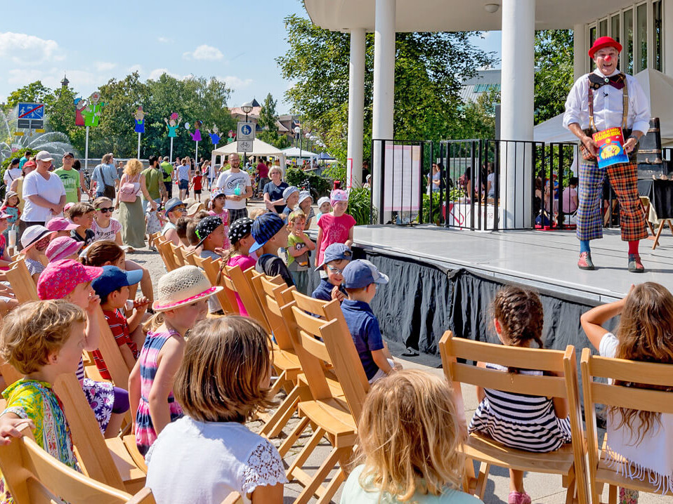 Kinder werden von Clown Show unterhalten